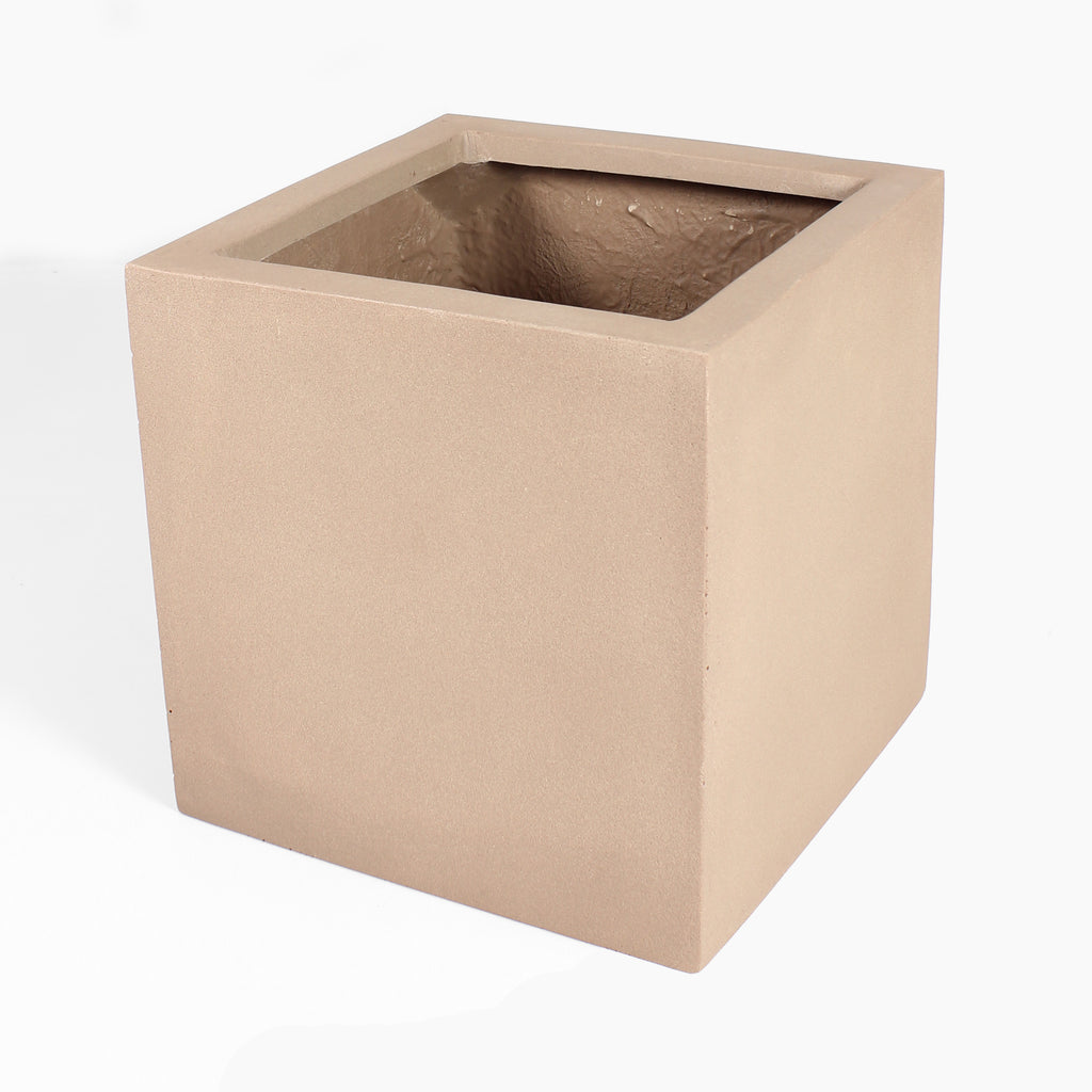 A square fiberstone planter pot in a warm sandy beige color, shown from a three-quarters perspective on a white background.