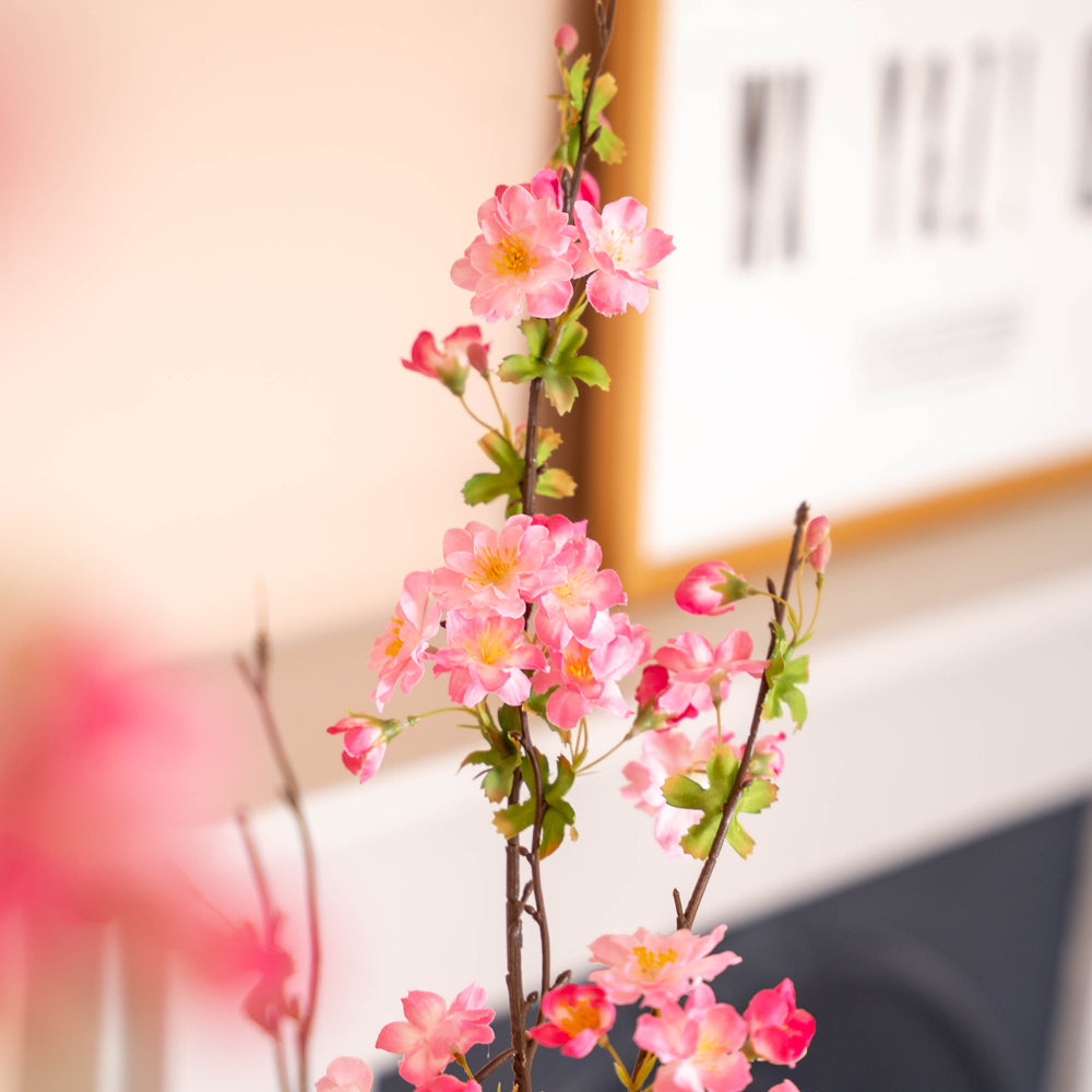 Artificial pink blossom flowers on a blurred background