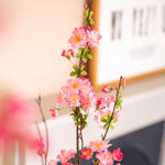 Artificial pink blossom flowers on a blurred background