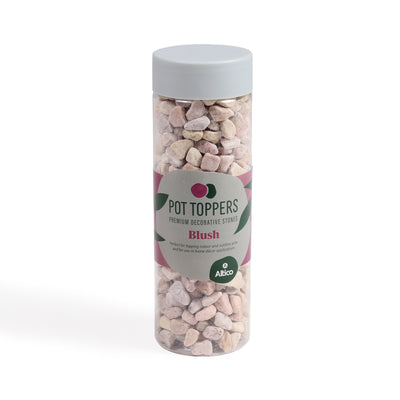 A clear plastic jar of pale pink decorative stones, with a gray lid and a white and pink label.