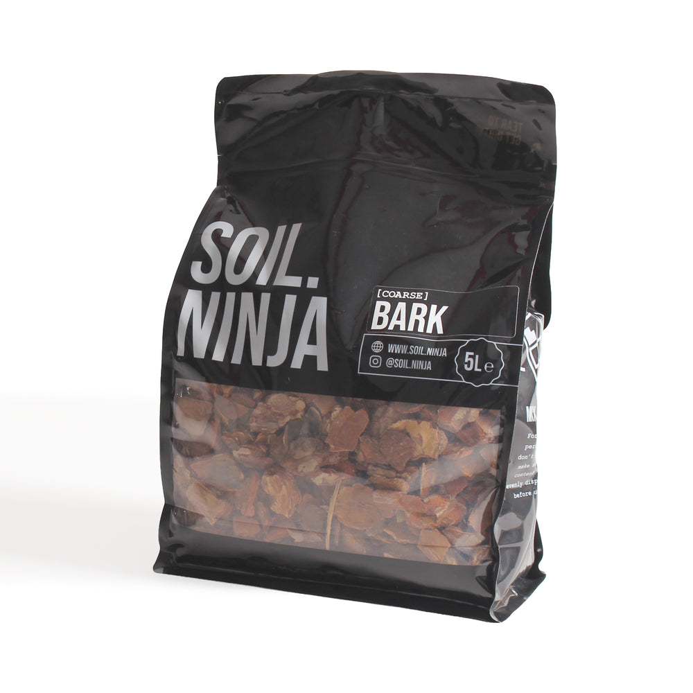 A 5-liter black bag of Soil Ninja Bark mulch, featuring a clear window that displays the brown bark chips inside, set against a plain white background.