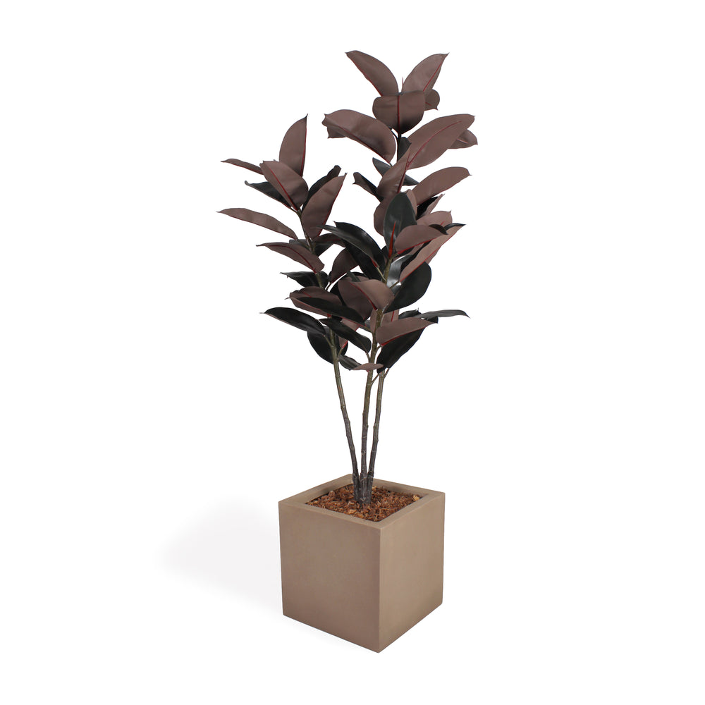 An artificial potted plant with dark reddish-brown glossy leaves in a square beige concrete-style planter topped with bark, shown on a clean white background.