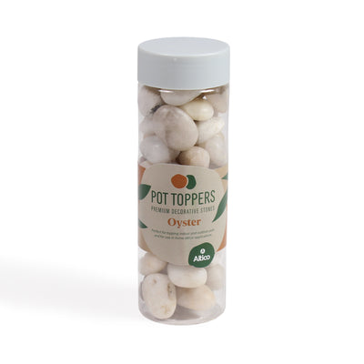 A clear plastic jar filled with large off-white stones, featuring a grey lid and a beige label with green and orange accents.