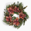 A festive holiday wreath featuring large, textured poinsettia flowers in dusty rose tones, mixed with green pine branches, eucalypts and small gold decorations on a white background.