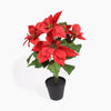 An artificial poinsettia plant with bright red petals and green leaves, potted in a simple black plastic starter pot against a clean white background.