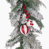 A festive Christmas garland branch decoration featuring a white pinecone, red and white ornaments with and clusters of red berries, isolated on a white background.
