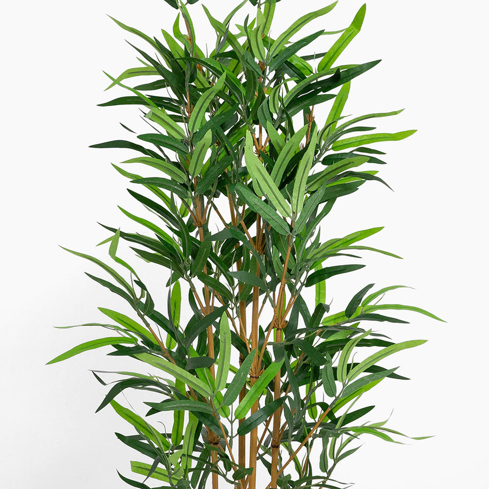 Artificial bamboo plant with green leaves on a white background