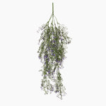 Hanging bundle of greenery with small purple flowers on a white background