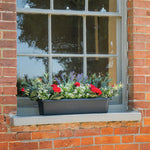 Window box with flowers on a brick window sill