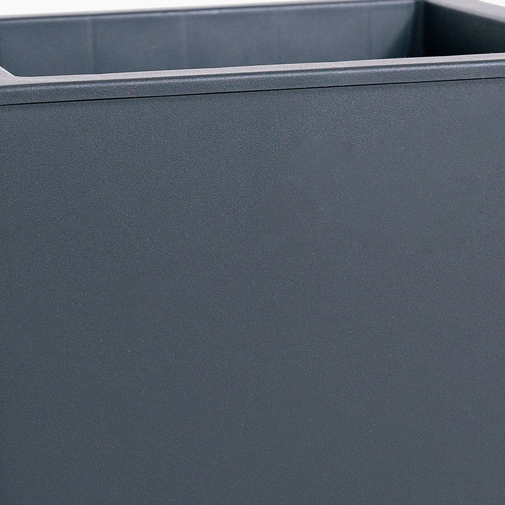 Close-up of a dark gray rectangular planter with a smooth surface.