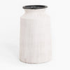 White textured vase with black rim on a white background
