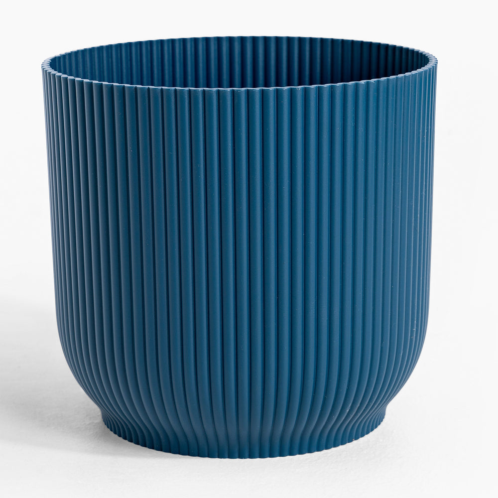 Blue ribbed pot on a white background