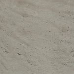 Close-up of a textured beige surface with small variations in color.