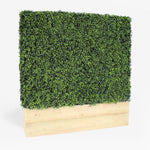 Artificial hedge with wooden base on a white background