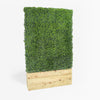 Artificial green wall panel in a wooden planter on a white background