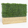 Rectangular wooden planter with artificial greenery on a white background
