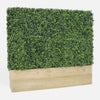 Artificial hedge in a wooden planter on a white background