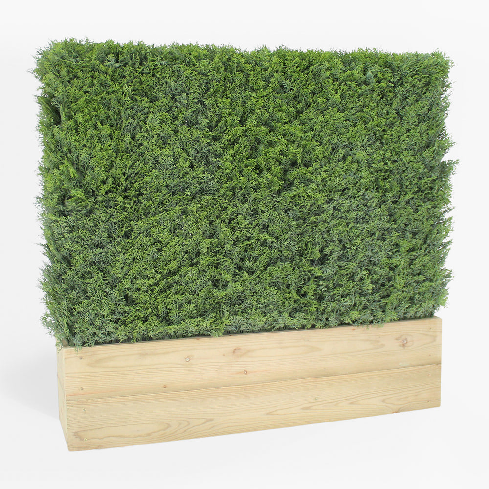 Artificial green wall panel with wooden base on a white background