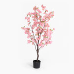 Artificial cherry blossom tree with pink flowers in a pot on a white background