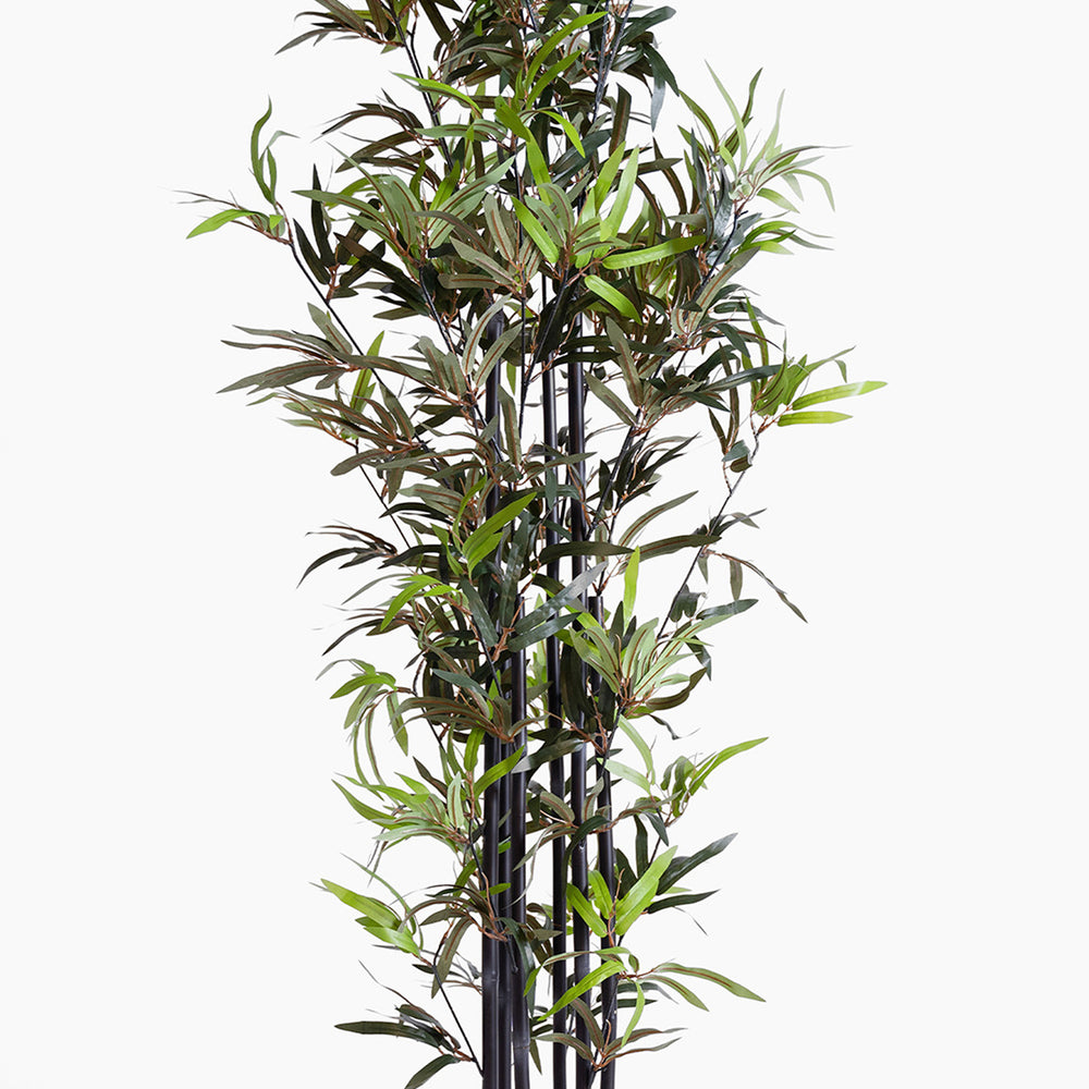 Artificial bamboo plant with green leaves on a white background