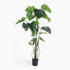 Artificial monstera plant in a pot on a white background