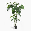 Artificial monstera plant in a pot on a white background