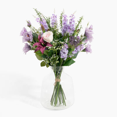 Bouquet of flowers in a clear vase on a white background