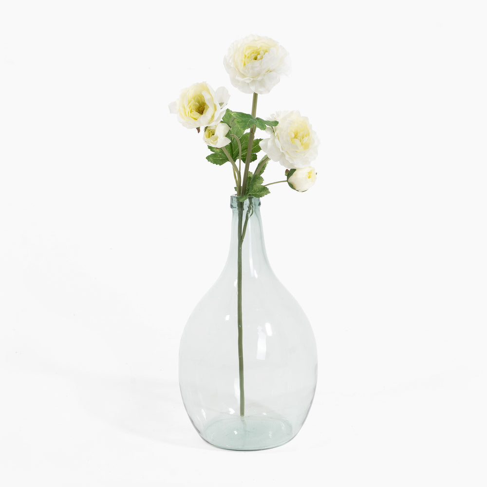 Clear glass vase with white flowers on a white background