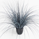 Faux potted plant with long, thin leaves on a white background