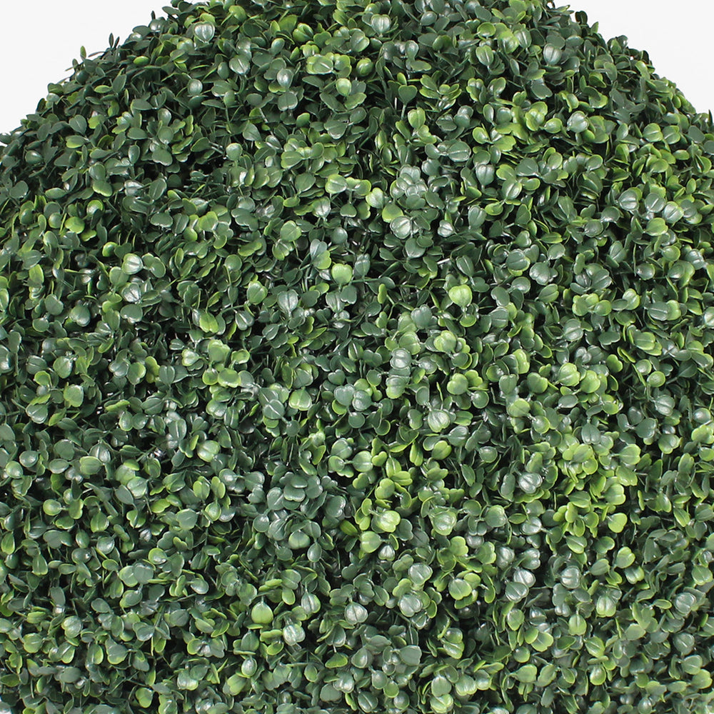 Close-up of a dense cluster of artificial green leaves