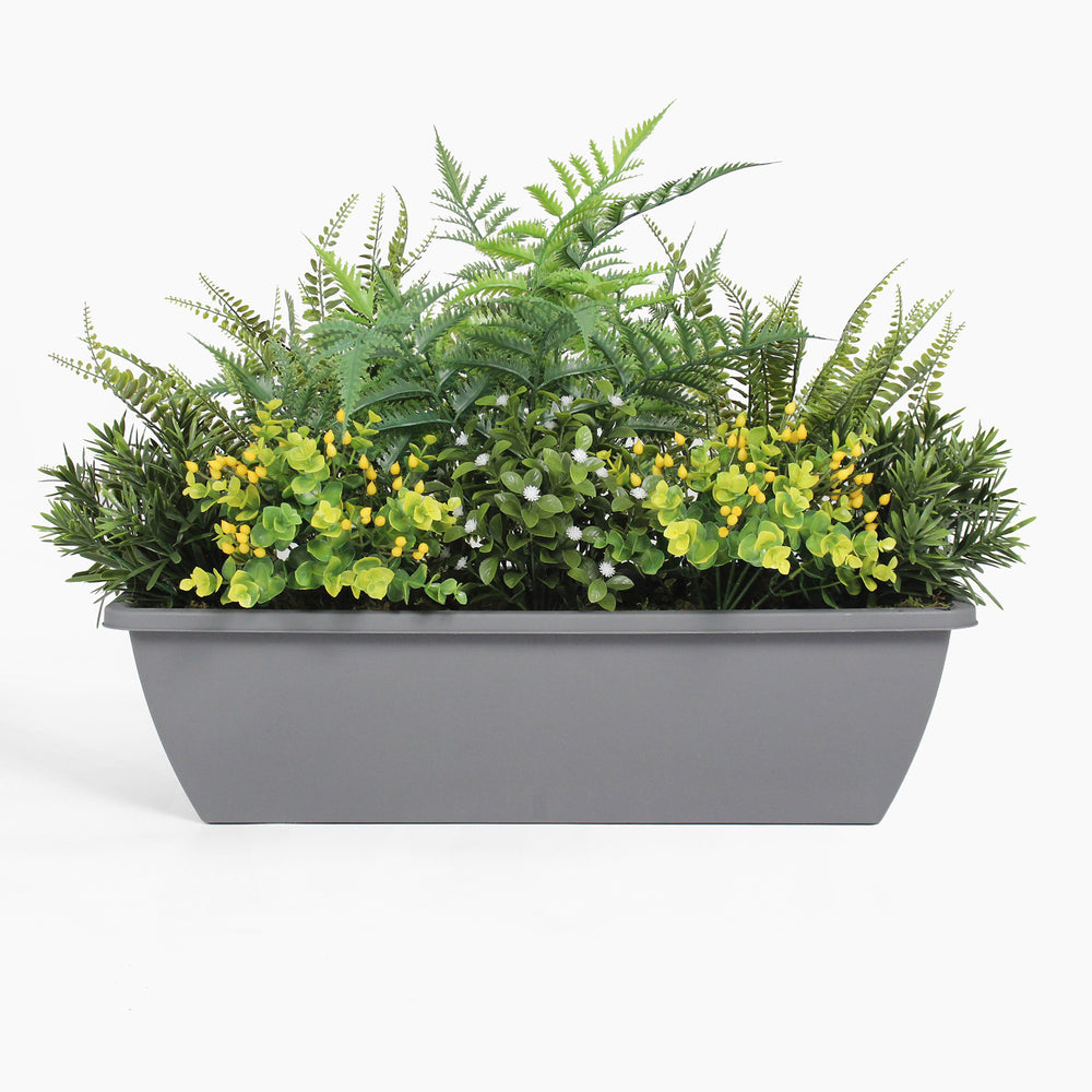 Gray planter with green ferns and yellow flowers on a white background