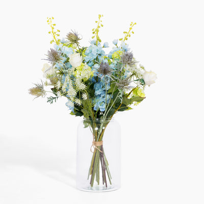 Bouquet of flowers in a clear vase on a white background