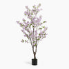 Artificial potted tree with light purple blossoms on a white background