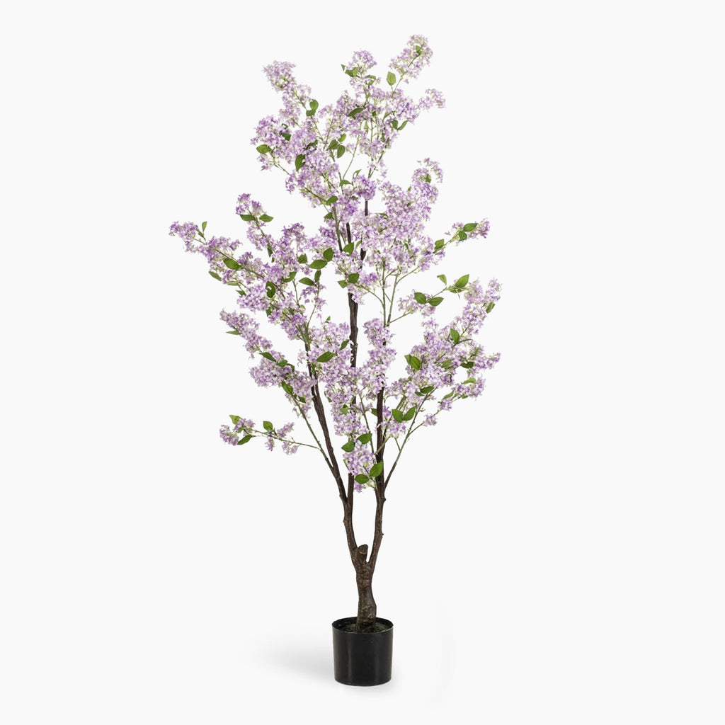 Artificial potted tree with light purple blossoms on a white background