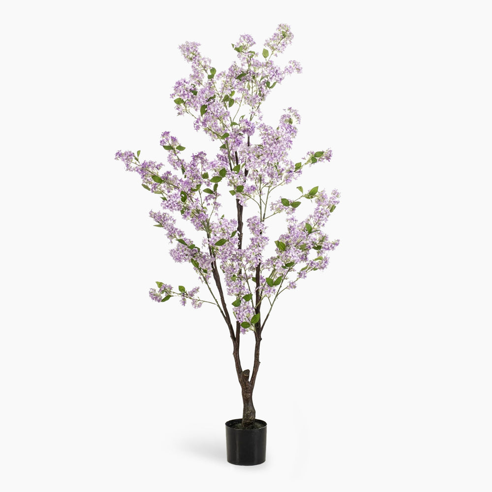 Artificial potted tree with light purple blossoms on a white background