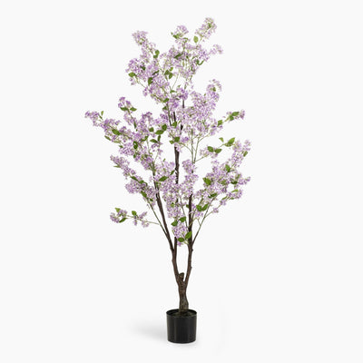 Artificial potted tree with light purple blossoms on a white background