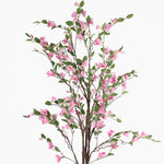 Artificial cherry blossom branch with pink flowers and green leaves on a white background