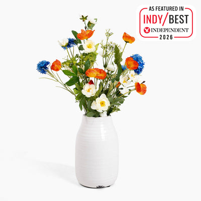 White vase with red, white and blue flowers on a white background, featuring 'Indy Best Independent 2026' badge.