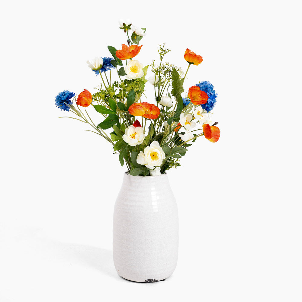 White vase with colorful flowers on a white background