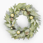 Decorative wreath with green leaves, gold ornaments, and pinecones on a white background
