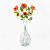Clear glass vase with sunflower stems on a white background