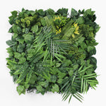 Artificial green wall with various types of leaves on a white background