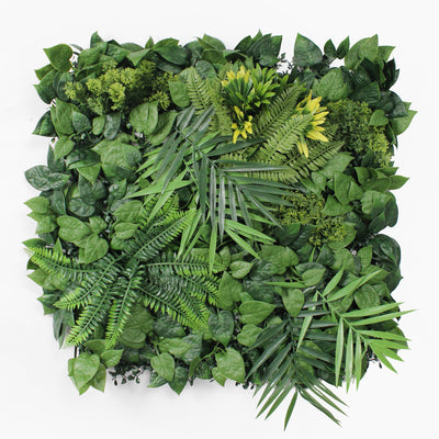 Artificial green wall with various types of leaves on a white background