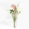 Bouquet of flowers in a clear vase on a white background