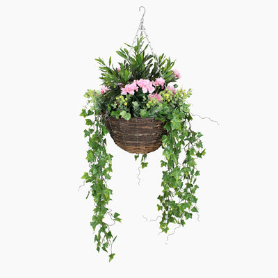 Hanging basket with greenery and pink flowers on a white background