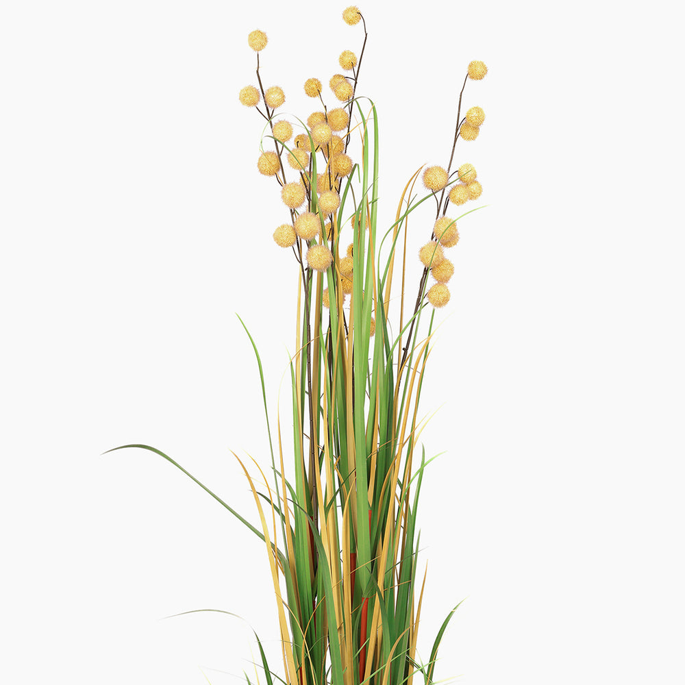 Artificial plant with yellow flowers and green stems on a white background