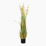 Artificial plant with yellow flowers and green leaves in a black pot on a white background