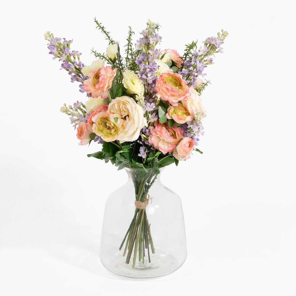 Bouquet of flowers in a clear glass vase on a white background