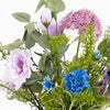 Assorted artificial flowers including pink, blue, and green on a white background