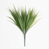 Artificial green palm leaf branch on a white background